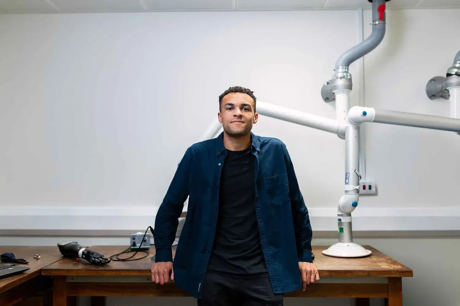 Man with blue shirt and black ve