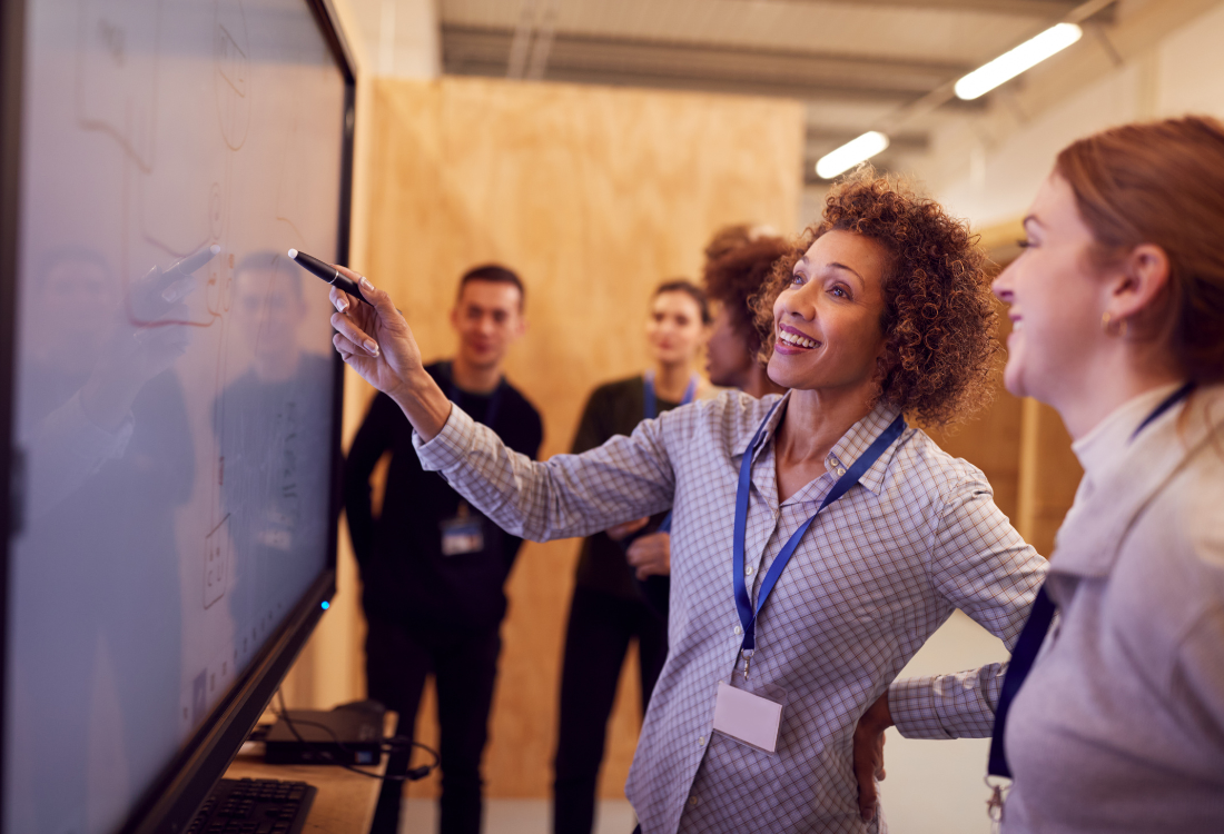 A woman presenting all the apprenticeship training courses available to another.